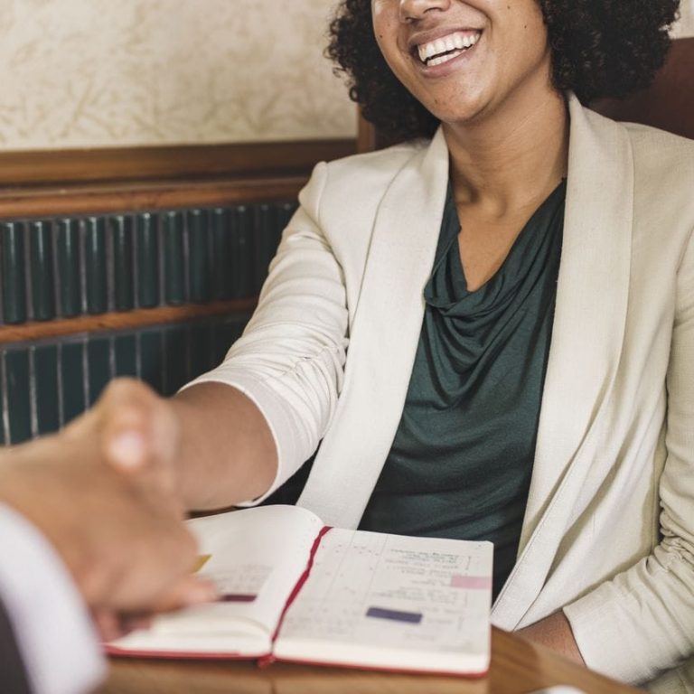 Woman shaking hands with business partner